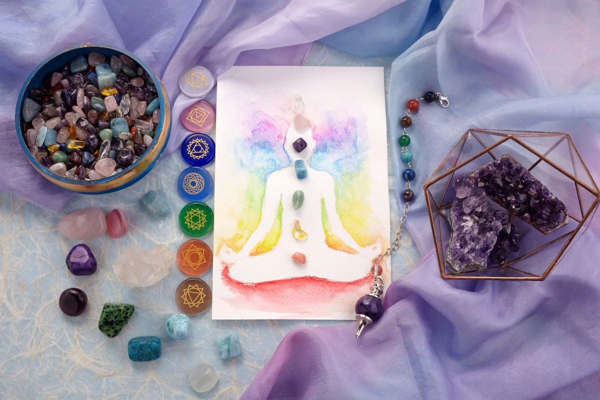 Chakra figure with healing crystals and gemstones representing vibrational energy therapy at Sassy Fae.